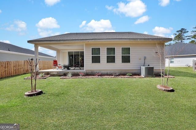 back of property with a patio area, fence, cooling unit, and a yard