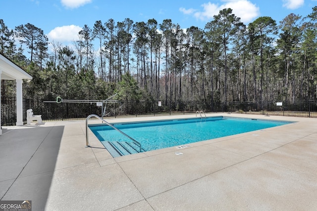 pool featuring a patio area and fence