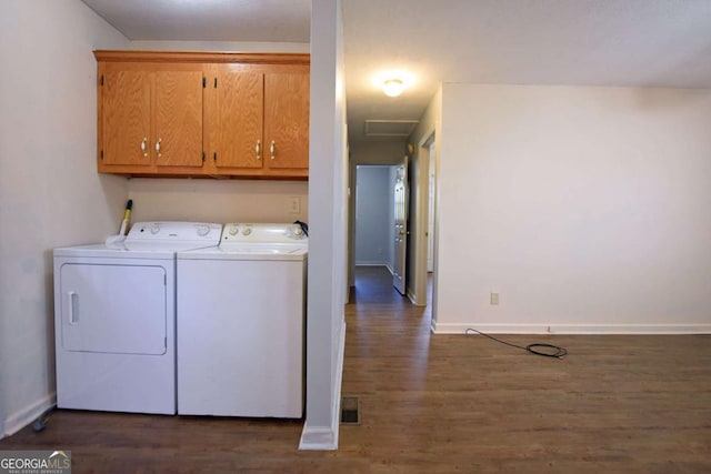 laundry room with cabinet space, baseboards, washer and dryer, and wood finished floors