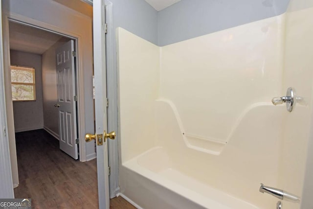 bathroom featuring shower / bathtub combination and wood finished floors