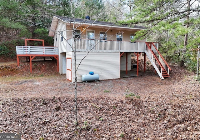 exterior space featuring stairway and a wooden deck