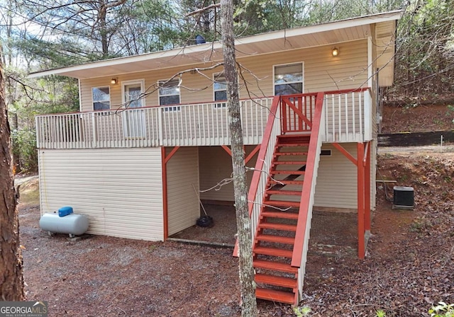 view of play area with covered porch, stairs, and cooling unit