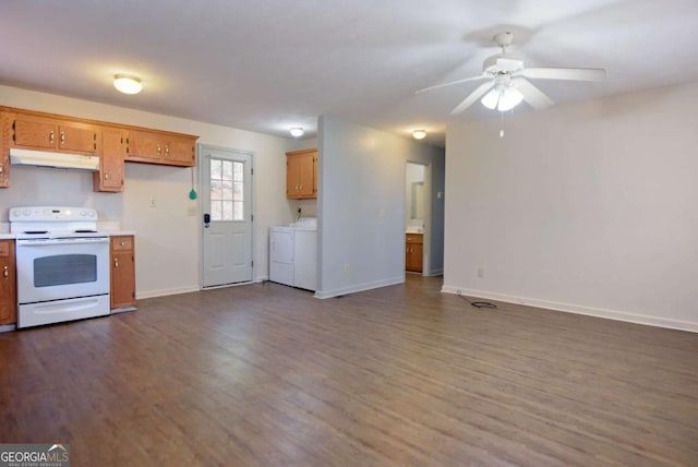 kitchen featuring dark wood-style floors, white electric stove, light countertops, independent washer and dryer, and under cabinet range hood