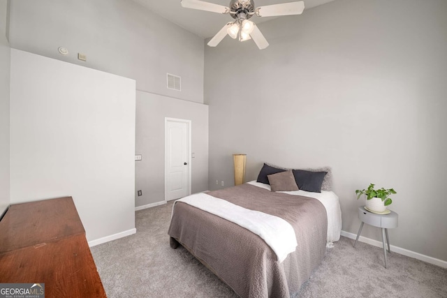 carpeted bedroom featuring high vaulted ceiling, visible vents, ceiling fan, and baseboards