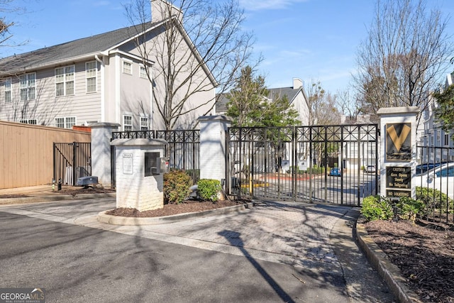 view of gate with a fenced front yard