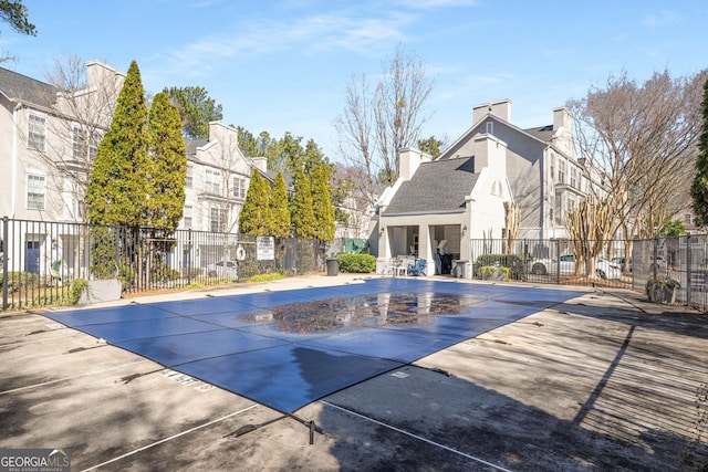 community pool featuring fence and a patio