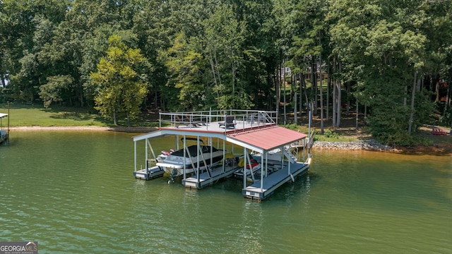dock area with a water view and boat lift