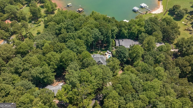aerial view featuring a wooded view and a water view