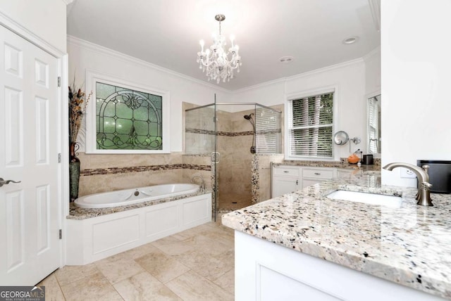 bathroom featuring an inviting chandelier, a shower stall, ornamental molding, vanity, and a garden tub