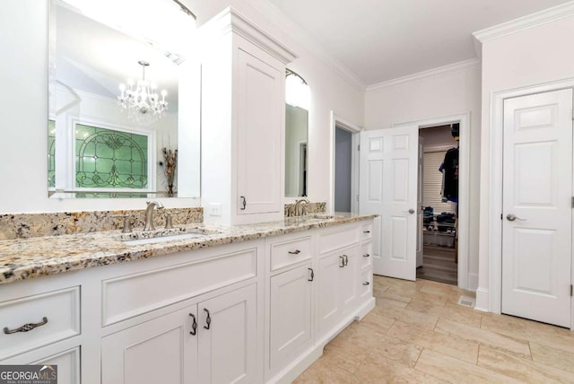 full bathroom with crown molding, double vanity, a chandelier, and a sink