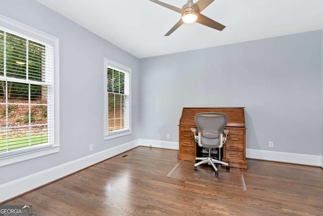 unfurnished office with wood finished floors, ceiling fan, and baseboards