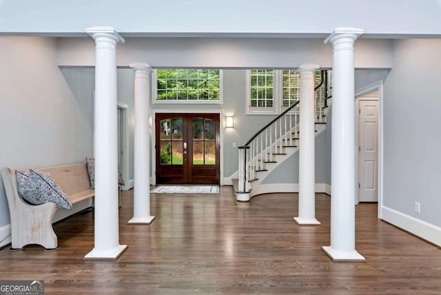 foyer entrance featuring stairs, wood finished floors, and baseboards