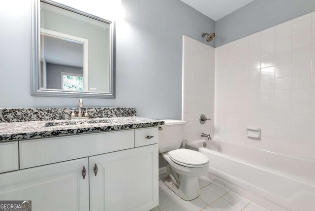 bathroom featuring vanity, tile patterned floors, toilet, and shower / bathtub combination