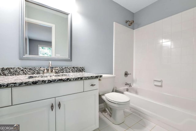 bathroom featuring toilet, tile patterned floors, washtub / shower combination, and vanity