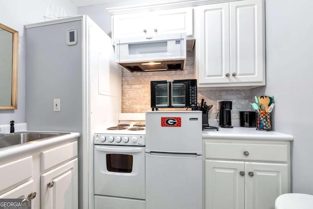 kitchen featuring tasteful backsplash, white appliances, white cabinetry, and exhaust hood