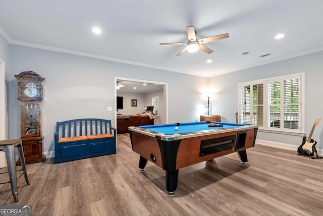 playroom featuring visible vents, a ceiling fan, wood finished floors, crown molding, and baseboards