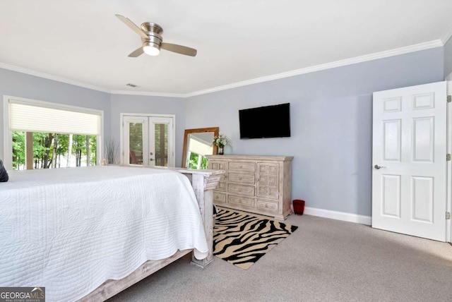 carpeted bedroom featuring crown molding, a ceiling fan, french doors, and baseboards