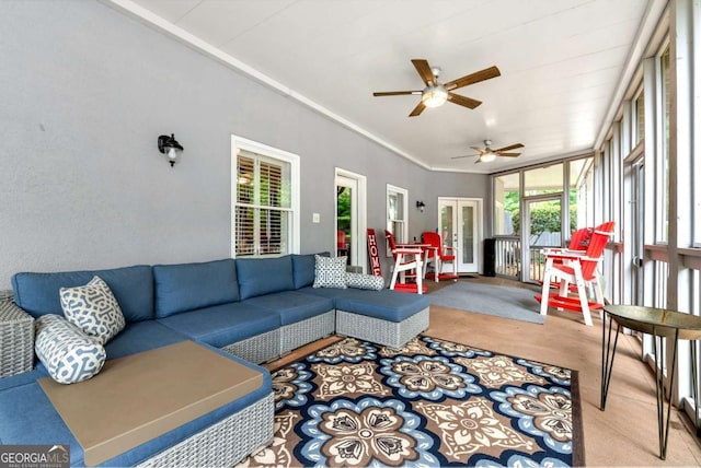 carpeted living room with a ceiling fan and crown molding