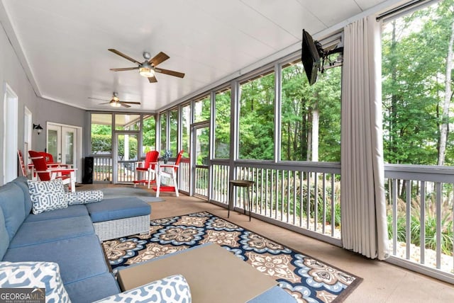 sunroom / solarium featuring ceiling fan and french doors