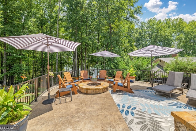 view of patio with a fire pit and fence