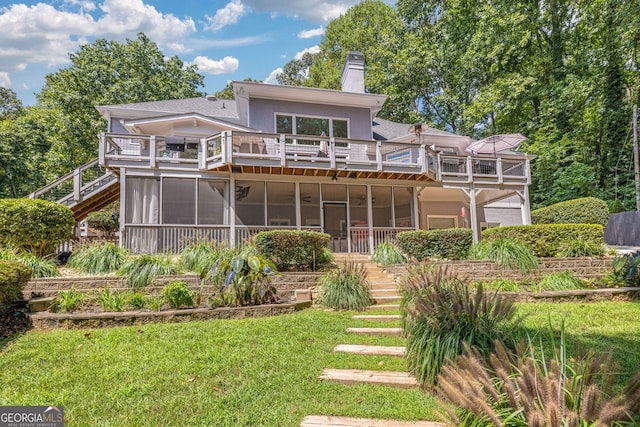 rear view of house with a sunroom, stairs, a balcony, and a chimney