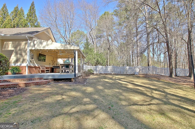 view of yard with a fenced backyard and a wooden deck