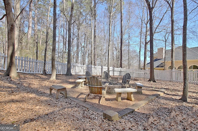 view of yard with a fire pit and fence