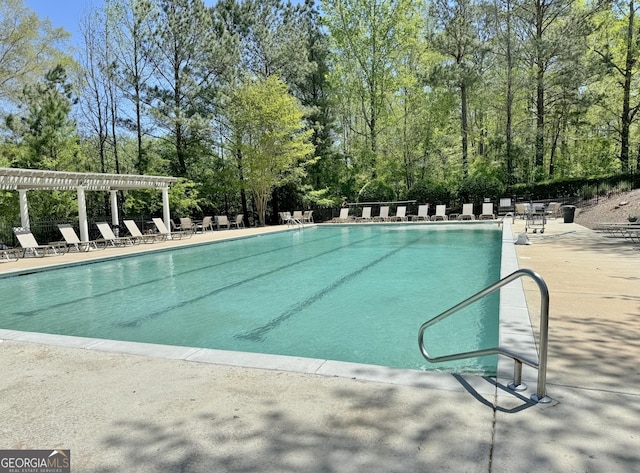 pool with a patio and a pergola