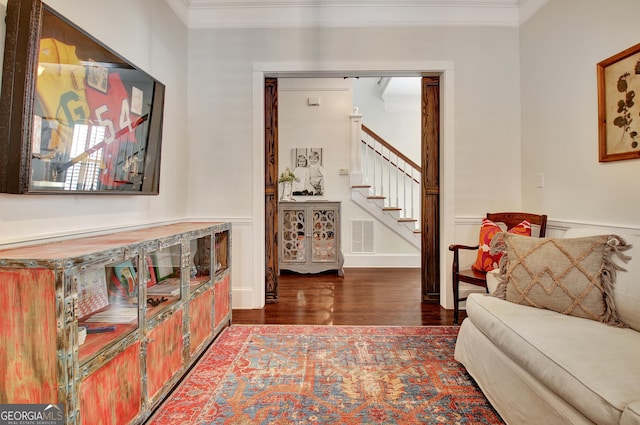 interior space with ornamental molding, stairway, wood finished floors, and visible vents