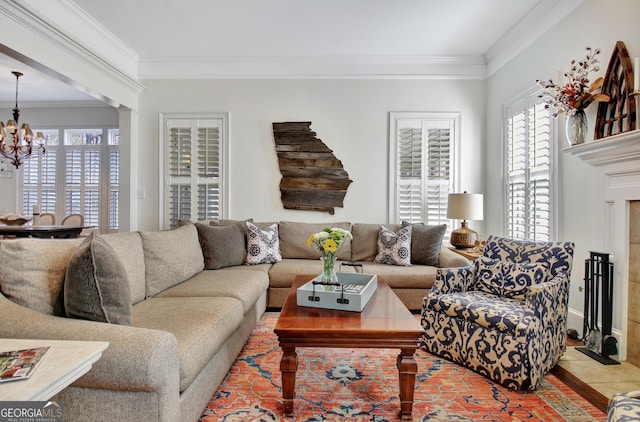 living area featuring a chandelier, crown molding, and light tile patterned floors