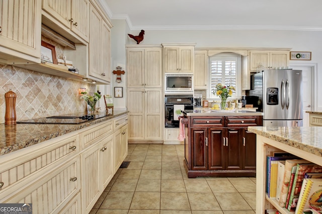 kitchen featuring black appliances, cream cabinets, light tile patterned floors, and ornamental molding