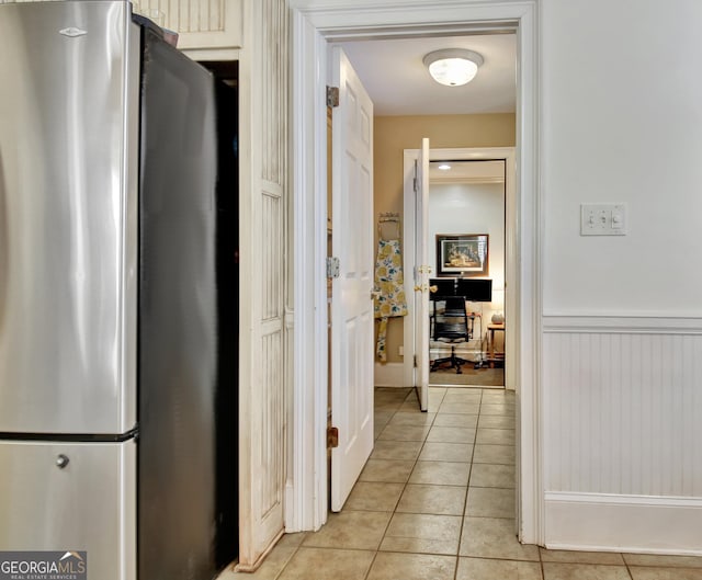 hallway with wainscoting and light tile patterned floors