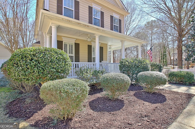 view of side of home with a porch and a ceiling fan