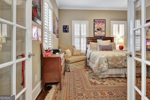 bedroom with ornamental molding, french doors, and wood finished floors