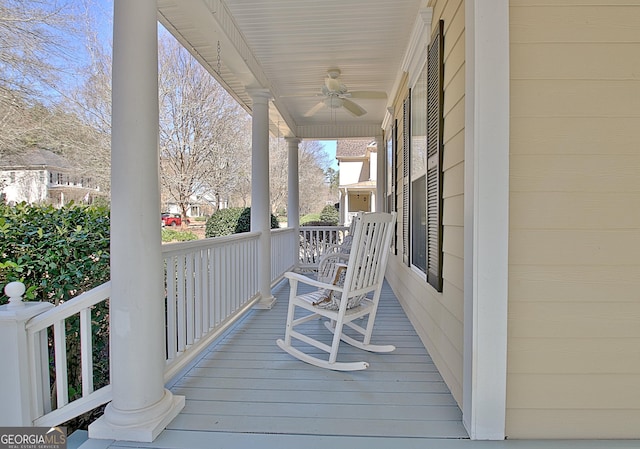 wooden deck with covered porch and a ceiling fan