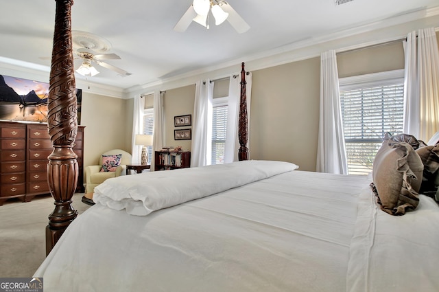 carpeted bedroom with a ceiling fan and crown molding