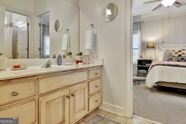 ensuite bathroom featuring crown molding, ceiling fan, connected bathroom, vanity, and tile patterned floors