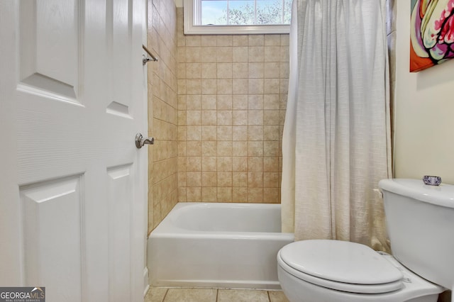 bathroom featuring toilet, tile patterned flooring, and shower / bath combo