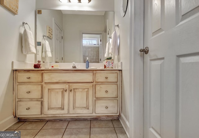 bathroom featuring baseboards, vanity, and tile patterned floors