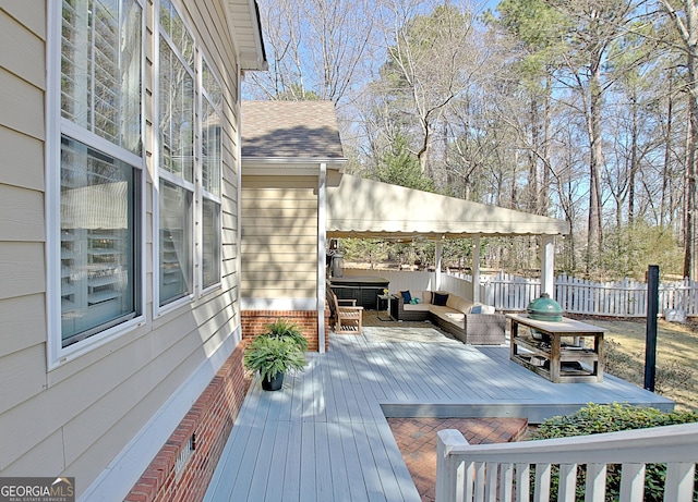 wooden terrace with fence and an outdoor hangout area