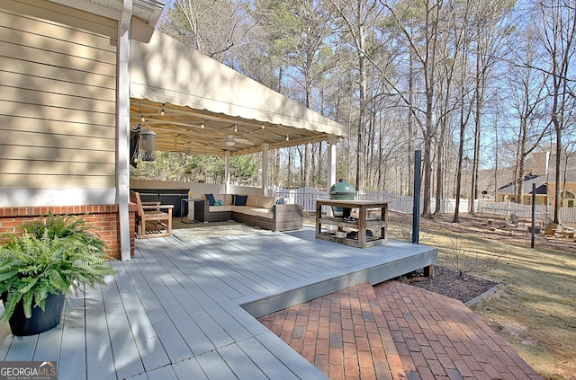 wooden deck with a grill and an outdoor living space