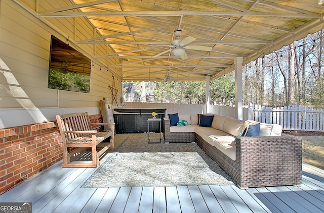 deck featuring an outdoor hangout area, ceiling fan, and fence