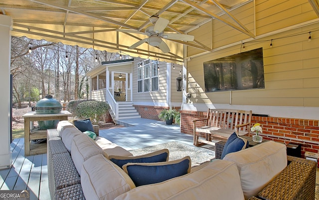 view of patio / terrace with ceiling fan, an outdoor hangout area, and a wooden deck