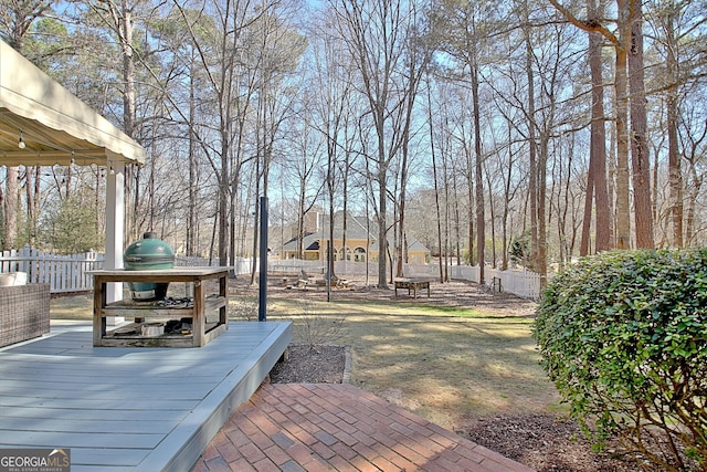 view of yard with a fenced backyard and a wooden deck