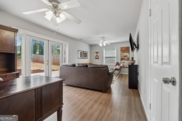 living area with light wood finished floors, french doors, baseboards, and a wealth of natural light