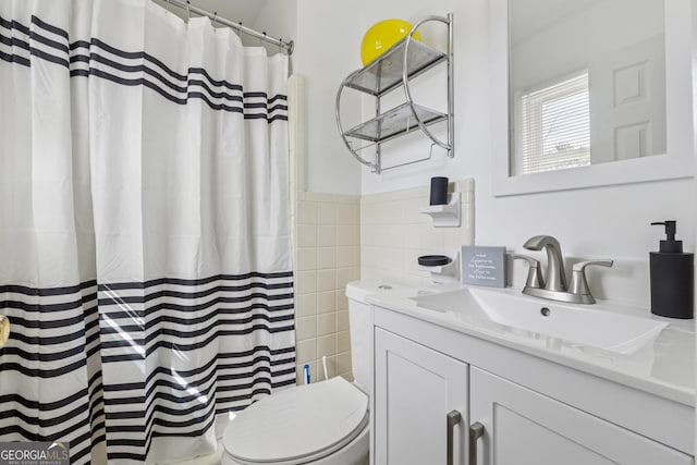 bathroom with vanity, toilet, tile walls, and a shower with curtain