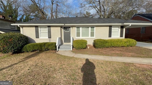 view of front of property with brick siding, a front yard, and an attached carport