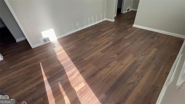 interior space featuring visible vents, baseboards, and wood finished floors