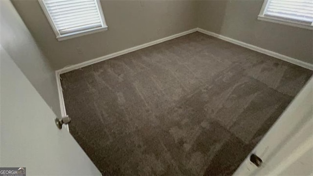 carpeted empty room with baseboards