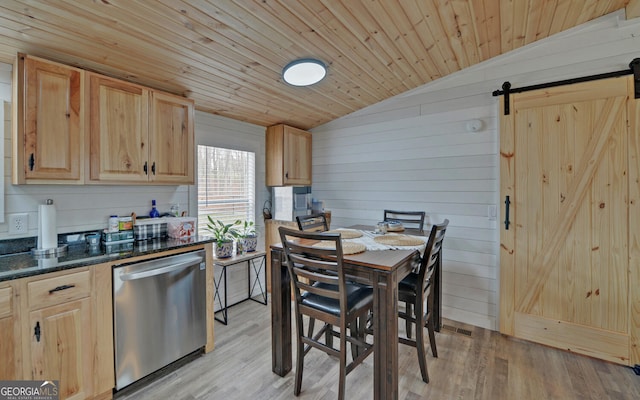 interior space featuring wood ceiling, vaulted ceiling, light wood finished floors, and a barn door